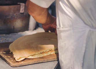 A man is cooking a pie in the market of chinatown, Malaysia. Street food.
