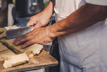 A man is cooking a pie in the market of chinatown, Malaysia. Street food.