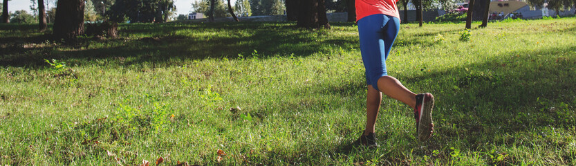 Woman runner jogging in city park. Copy space