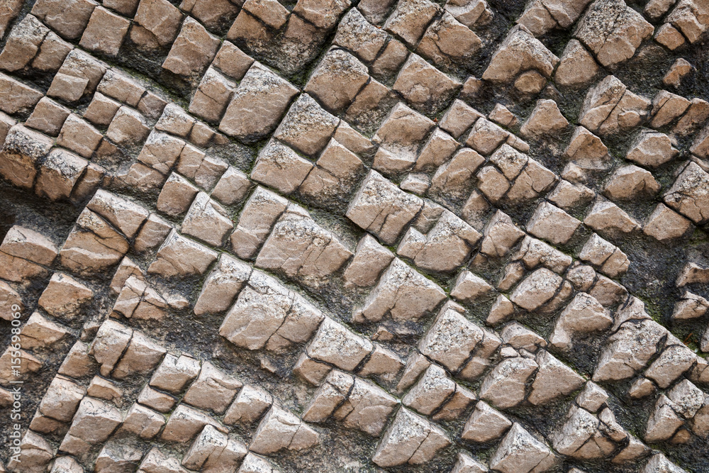 Aufkleber close-up of a bizarre rock surface texture with vignetting.