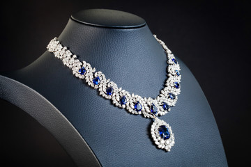 diamonds with dark blue sapphire necklace on the black background - obrazy, fototapety, plakaty