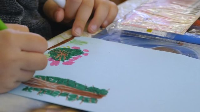 Children paints nature in kindergarten