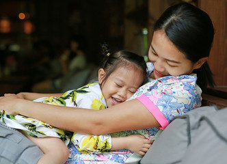 Obraz premium Happy loving family. mother hugging her child on sofa.