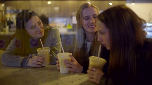 Friends Take A Sip Of Their Coffee Drinks, Then Girl In Middle Tries All Three Drinks At Once, Friends Laugh