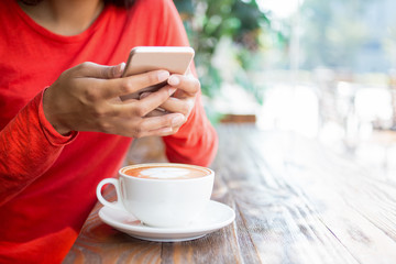 Close-up of unrecognizable woman using smartphone