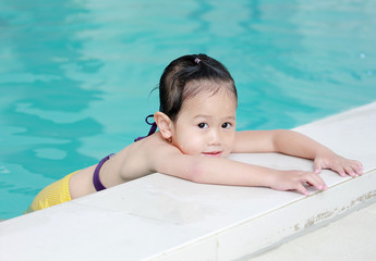 Portrait of little girl in swimming pool.