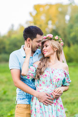 Couple embracing on nature. Portrait of Young romantic man and woman standing and hugging each other with tenderness outdoors. Young love concept.