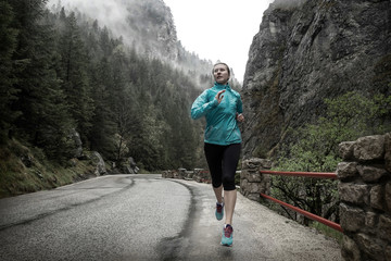 Running on the road around mountains under snowly rain.