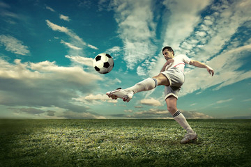 Soccer player with ball in action outdoors.