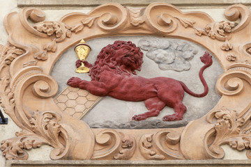 Relief on facade of old building, red lion, Prague, Czech Republic