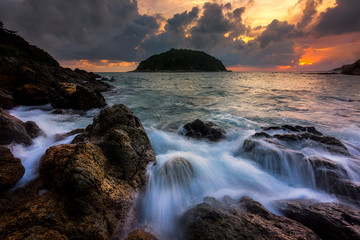 Seascape awesome wave on the rock with sunset and rain cloud at beach in phuket thailand
