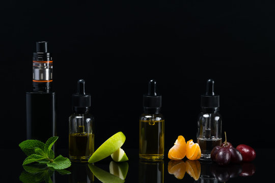 Black background with a set of fruit flavors with reflection on the surface for an electronic cigarette