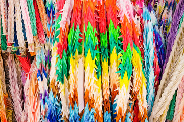 Colorful paper birds hanging together. Texture of Origami crane in lines.