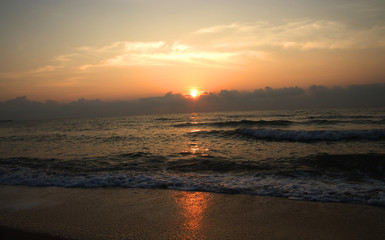 silhouettes on beach at sunrise