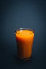 Fresh orange juice on black background.