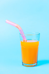 Fresh orange juice on blue background.