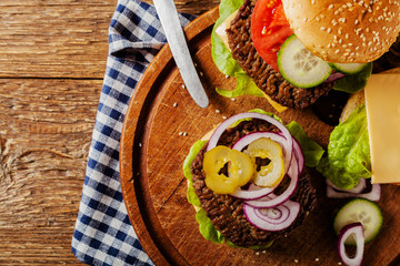 Homemade, beef hamburger with cheese and vegetables.