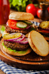 Homemade, beef hamburger with cheese and vegetables.