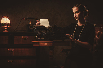 Fototapeta na wymiar Beautiful young woman typing in retro interior