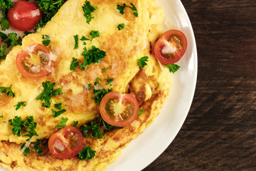 Omelette with parsley, cherry tomatoes, and copyspace