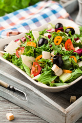 Italian salad with fresh vegetables with black olives and Parmesan cheese.