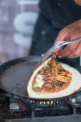 Folding Dosa While Cooking on a Hot Skillet