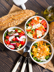 Colorful vegetable salad bowl for lunch on wooden rustic background