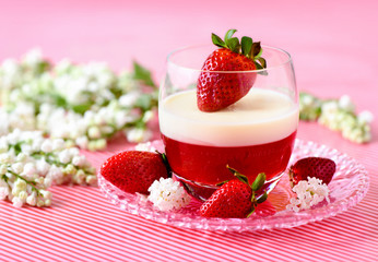 Italian dessert pannacotta with strawberries and flowers