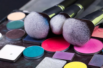 Eye shadow palette in natural colours and makeup brushes