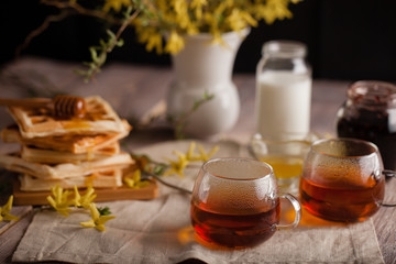 Fototapeta na wymiar Waffles, tea, honey and milk on a neutral background