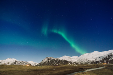 Fototapeta na wymiar Northen lights over the mountain in Iceland