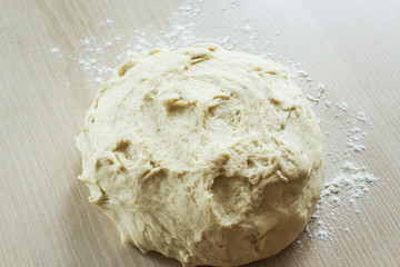 Raw dough for the preparation of traditional Italian focaccia bread. Selective focus.