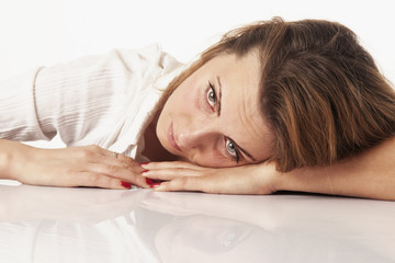 Fototapeta premium Troubled woman biting her fistas as symbol of failure in business. Close up portrait.