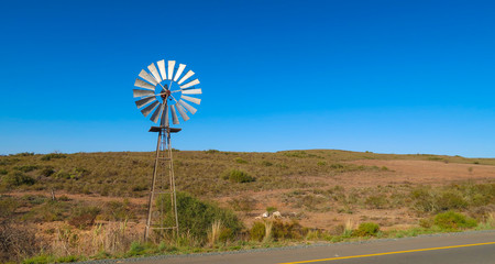 Windmill by the Mountains in the Farmlands
