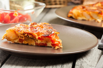 Tortilla de patatas. Spanish omelette with sausage chorizo, potatoes, paprika and egg, accompanied by olive oil