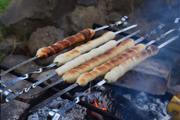 bread sticks of dough cooked on a fire. Italian breadsticks from wholemeal flour with herbs