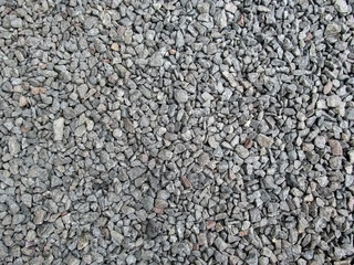 Abstract gray and beige crushed stone background - top view. Gravel poured in a uniform even layer