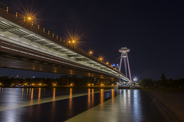 Fototapeta premium The panoramic view of UFO tower on the Danube bridge in Bratislava by night