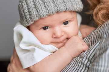 Woman holding baby, close up. Face of an infant.