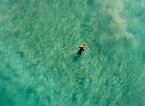 Aerial view of man surfing in the Atlantic ocean