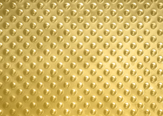 Abstract background of golden drops on a golden metal plate,