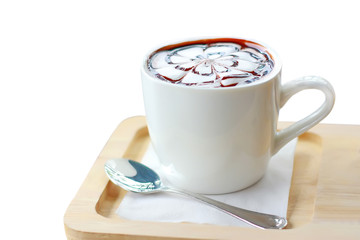 cup of hot chocolate with foam in the form of flower with wood plate
