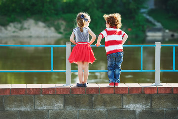 cute little hugging children on the promenade