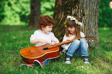 cute little children playing guitar