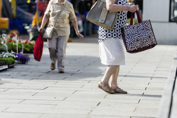 Alte Frau mit zwei Einkaufstaschen