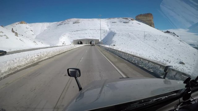 Forward Facing Dashcam-style footage from the interior of a Semi Truck traveling down a rural US Highway. 