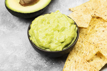 Traditional Latin American sauce guacamole in a bowl and nachos