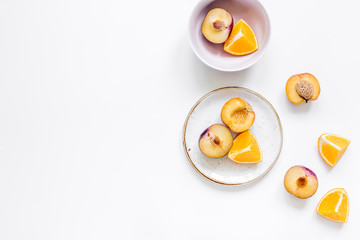 orange and peach summer sweet dessert on plates white background top view mock-up
