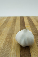 A bulb of garlic on wooden board 