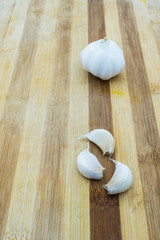 A bulb of garlic on wooden board 